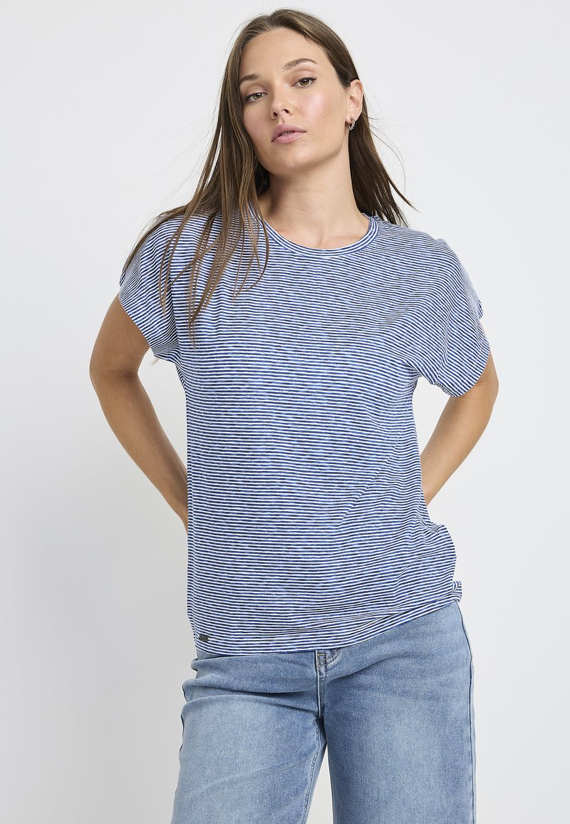 Short-sleeve T-shirt featuring blue and white horizontal stripes, round neckline, soft fabric, and relaxed fit. Paired with light blue jeans.