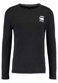 Musta pitkähihainen paita, joka on valmistettu pehmeästä kankaasta. Ominaisuuksiin kuuluu pyöreä pääntie ja valkoinen "RAW"-logo vasemmassa rinnassa.