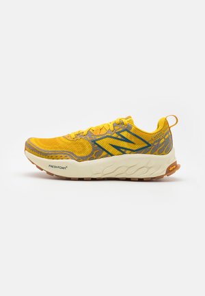 Yellow running shoe with grey accents, breathable mesh upper, textured design, cushioned midsole, and rubber outsole. "Fresh Foam" label visible.