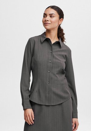 Graues Langarmshirt mit vertikalen Streifen, Knopfverschluss, spitzem Kragen und abgerundetem Saum. Hergestellt aus glattem Stoff.