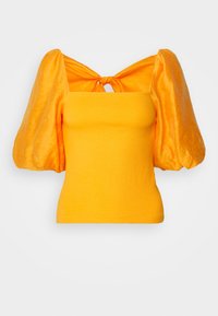 Haut ajusté jaune vif avec une large texture côtelée, avec de grandes manches courtes bouffantes brillantes et un petit détail noué en forme de trou de serrure à l'encolure.