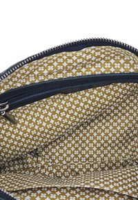 Intérieur marron et crème d'un sac zippé, présentant un motif floral avec de petits accents géométriques et une fermeture éclair foncée.