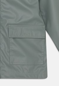 Petit Bateau JUNIOR CIRE UNISEX - Regnjakke - thuya