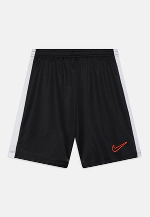 Pantaloni sportivi neri con pannelli laterali bianchi, vita elastica e logo rosso Nike nella parte anteriore sinistra in basso. Tessuto liscio e leggero.