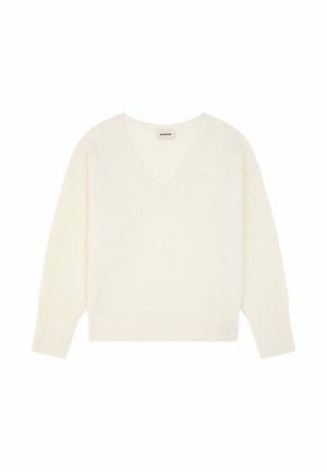 Pull à col en V, à manches longues, de couleur blanche avec un motif texturé en tricot. Présente un ourlet et des poignets côtelés, fabriqué en fil doux.
