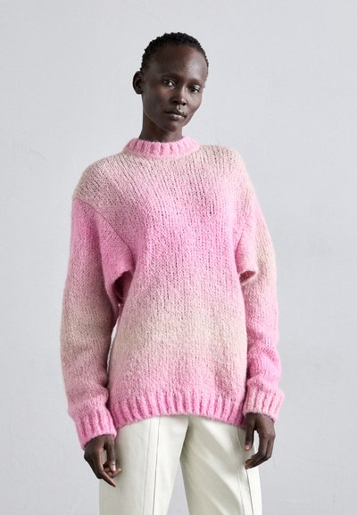 Pulover tricotat roz, cu un design gradient, manșete și tiv cu riburi, și guler înalt. Textură moale, cu umeri lăsați.