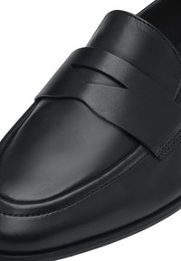 Black leather loafer shoe featuring a wide band across the upper with a cut-out detail, smooth texture, and reinforced stitching along the edges.