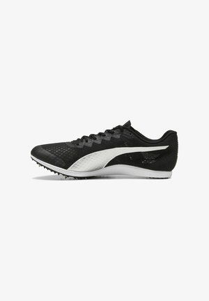 Black athletic shoes with a textured upper, featuring a white accent logo, low-profile design, and spiked outsole for traction.
