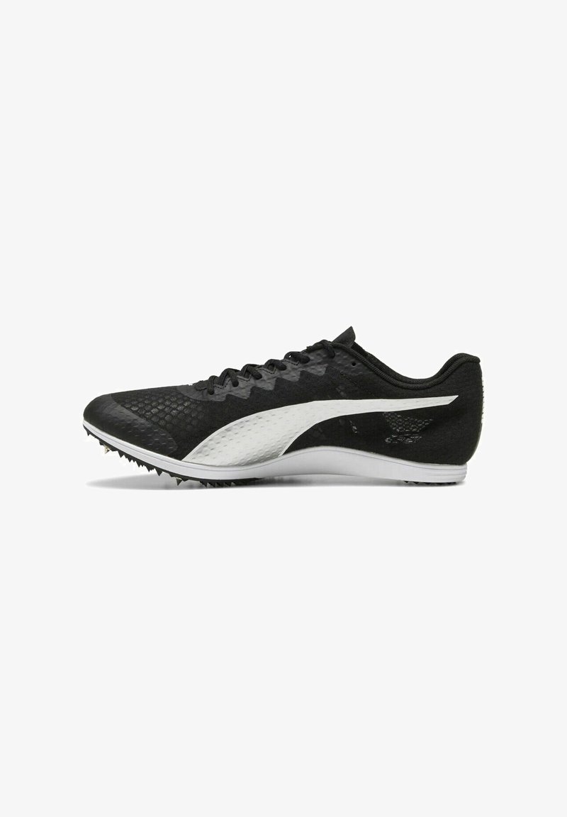 Black athletic shoes with a textured upper, featuring a white accent logo, low-profile design, and spiked outsole for traction.