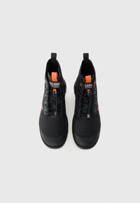 Black high-top shoes with a smooth texture, elastic laces, and orange accents on the tongue and side. Rubber sole for traction.
