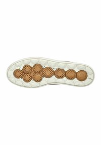 Suola di una scarpa con un motivo decorativo caratterizzato da accenti circolari beige, materiale in gomma testurizzato e un bordo bianco che circonda la suola.
