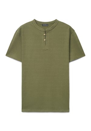 Short-sleeve olive green shirt with textured fabric, round collar, and two front buttons beneath the neckline.