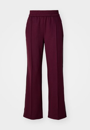 Brūnas platas kāju bikses ar elastīgu jostasvietu, sānu kabatām un kontrastējošām melnām sānu svītrām. Gluda auduma struktūra ar nelielu spīdumu.