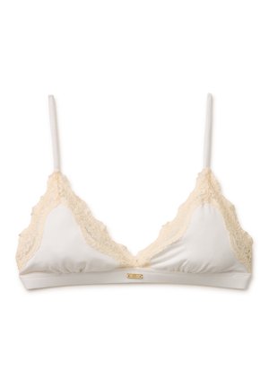 Soutien-gorge triangle blanc avec fines bretelles réglables et bordure en dentelle beige sur les bords, présentant une petite étiquette logo dorée sur le bandeau.