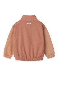 Long-sleeve pullover in muted peach and beige tones, featuring a collar, elasticized cuffs, and waistband. Tag visible at the neck.