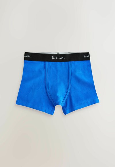 Boxer homme bleu avec ceinture noire affichant le logo blanc "Paul Smith", posé à plat sur un fond clair.