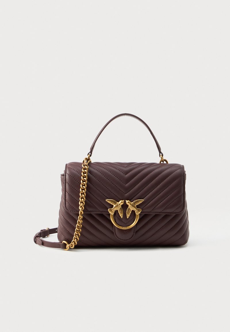 Quilted burgundy leather handbag with a gold-tone bird motif clasp, chain strap, and top handle; features a rectangular shape and smooth texture.