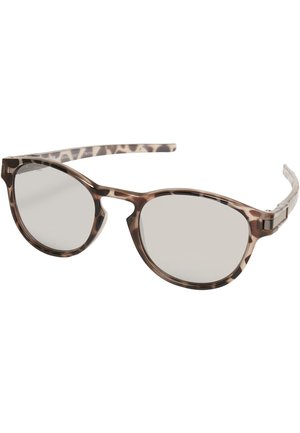Lunettes de soleil écaille de tortue marron avec des verres ronds, des branches fines et une monture en plastique lisse. Les verres sont légèrement miroités et réfléchissants.