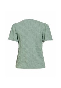 Blouse texturée vert sauge à manches courtes avec épaules bouffantes et motif floral en relief, vue de dos.