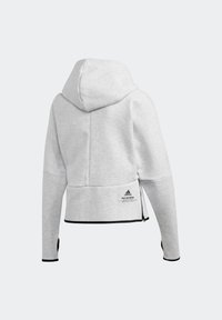 Sweat à capuche gris clair avec manches longues, bordure noire, fermeture éclair latérale et logo Adidas avec le texte « Built for Purpose » en bas du dos.