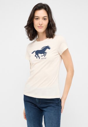 Beige Baumwoll-T-Shirt mit einem navyfarbenen Pferde-Graphic und dem Text "MUSTANG" darunter. Kurzärmelig und mit einem taillierten Schnitt.