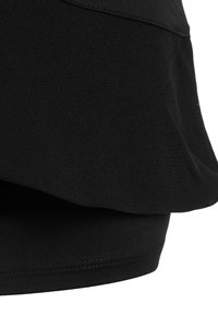 Black top featuring a textured upper layer with a smooth hem, crafted from lightweight material. The design includes a curved silhouette.