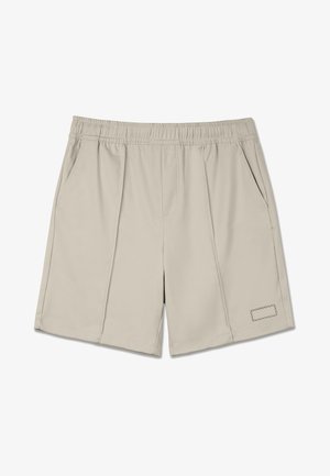 Beezid spordilühikesed püksid, mis on valmistatud pehmest kangast. Omavad elastset vööd, kahte küljetaskut ja dekoratiivset õmblusega silti ääres.