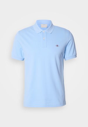 Light blue short-sleeve polo shirt made of cotton, featuring a two-button placket and a small embroidered logo on the left chest.