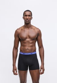 Melni bokseršorti ar zilu "BJÖRN BORG" jostasvietu. Audums izskatās gluds un cieši pieguļošs, paredzēts komfortam un atbalstam.