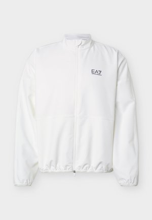 Fehér cipzáras dzseki rugalmas mandzsettákkal és szegéllyel, bal mellrészen fekete "EA7 Emporio Armani" logóval.