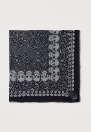 Dark scarf with a pattern of light skulls and floral motifs arranged in a square border design.