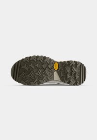 Light-colored hiking shoe sole featuring a rugged, textured pattern. Includes a prominent yellow Vibram logo for traction.