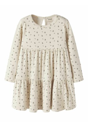 Crèmekleurige peuterjurk met lange mouwen, kleine zwarte bloemenprint en geplooide rokdetaillering.
