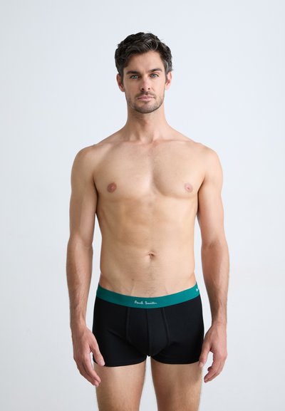 Boxer-briefs noirs pour hommes avec une taille en teal, présentant une texture lisse et un ajustement serré. La ceinture comporte des détails de marque blancs.