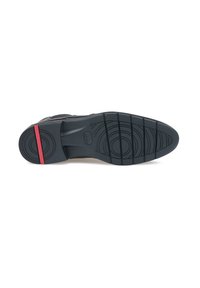 Soletta di scarpa in gomma nera con un motivo di presa testurizzato e accenti circolari. Presenta una striscia rossa sul tallone, che migliora la visibilità e il design.