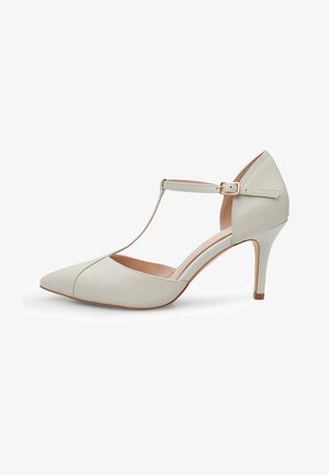 Chaussure à talon haut beige clair avec un bout pointu, un design à bride T, en cuir lisse et un talon aiguille de 7,5 cm.