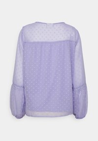 Lavender, sheer blouse featuring polka dots, long puff sleeves with elastic cuffs, and a gathered back design for a relaxed fit.