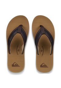 Καφέ σαγιονάρες με υφασμένο καφέ πέλμα, καφέ δερμάτινα λουράκια και διακριτικό λογότυπο στο πέλμα.