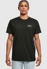 Black cotton t-shirt featuring a crew neck and short sleeves, with white printed text "For the Family" on the left chest.