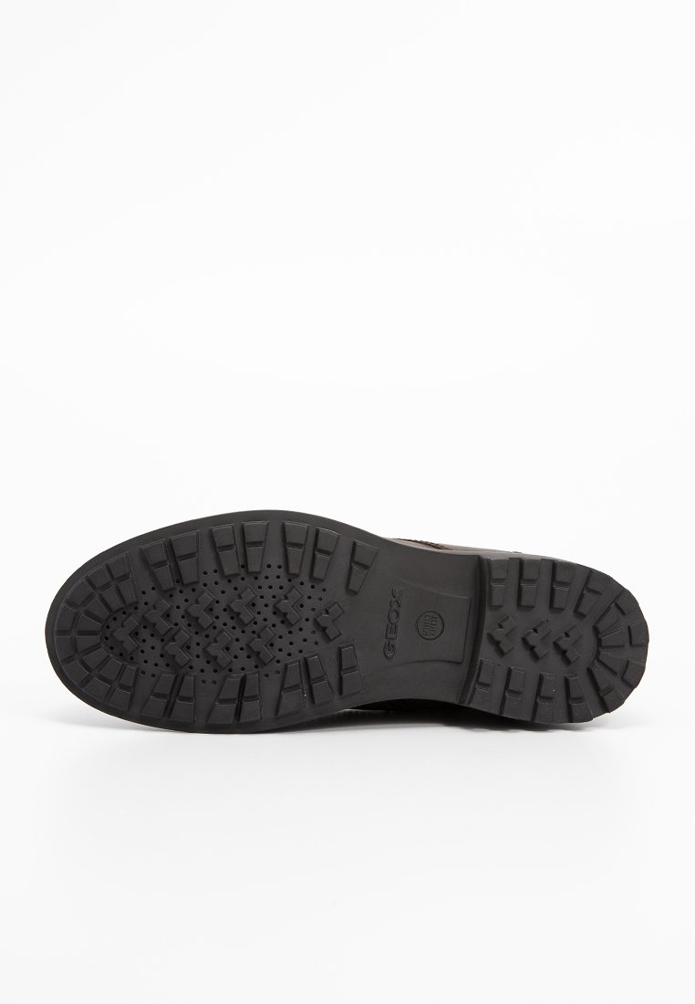 Podeszwa czarnego buta z głębokim bieżnikiem i perforacjami zapewniającymi wentylację, z widocznym logo marki Geox na środku.