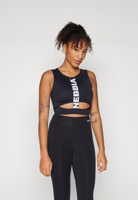 Black sports bra with cut-out design, featuring a white logo stripe. Paired with high-waisted black leggings for a complete athletic outfit.