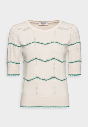 Strickpullover in Creme mit kurzen Ärmeln, verziert mit grünen Wellenmustern und gewellten Kanten. Leichter Stoff mit geripptem Halsausschnitt und Saum.