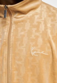 Karl Kani CHEST SIGNATURE MONOGRAM VELVET - Sportinė striukė - sand