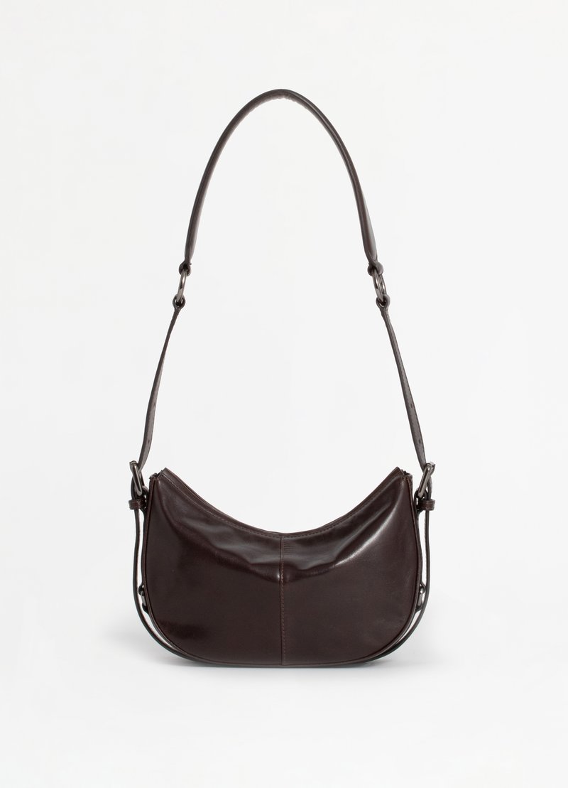 Dark brown leather shoulder bag with a curved shape, adjustable strap, and smooth texture. Features a zip closure and minimal seams.
