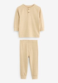 Beige pamut otthoni viselet szett, amely hosszú ujjú felsőből áll, három gombbal és bordázott mandzsettákkal, elasztikus derékú leggingsszel párosítva.