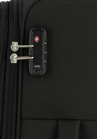 Black suitcase with a textured fabric exterior, featuring a TSA-accepted lock and dual metallic zippers. Hardware secured on the side.