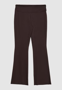 Pantaloni yoga marroni scuri con vita arricciata e gambe svasate, distesi su uno sfondo chiaro.