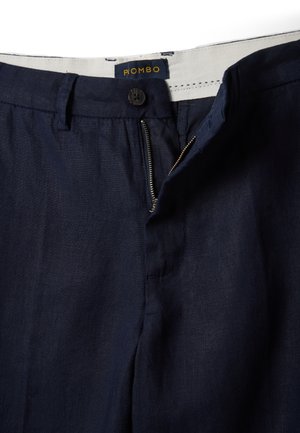 Navy blue pants with partially open zipper, button closure, belt loops, and white waistband featuring "PIOMBO" label.