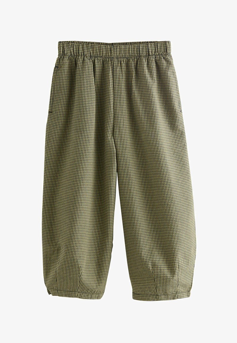 Zaļas un melnas rūtainas bikses ar elastīgu jostu, īsu garumu un sānu kabatām. Izgatavotas no viegla auduma.