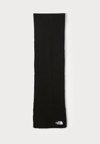 Écharpe en tricot noire avec une texture ribbed aux extrémités. Présente une petite étiquette de logo blanche. Forme longue et rectangulaire pour un port polyvalent.